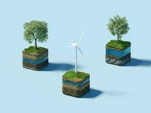 Eine Windkraftanlage und zwei Bäume