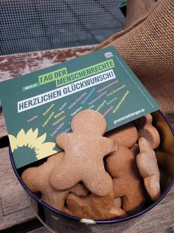 Plätzchen in Menschenform in einer Schale mit der Postkarte zum Tag der Menschenrechte